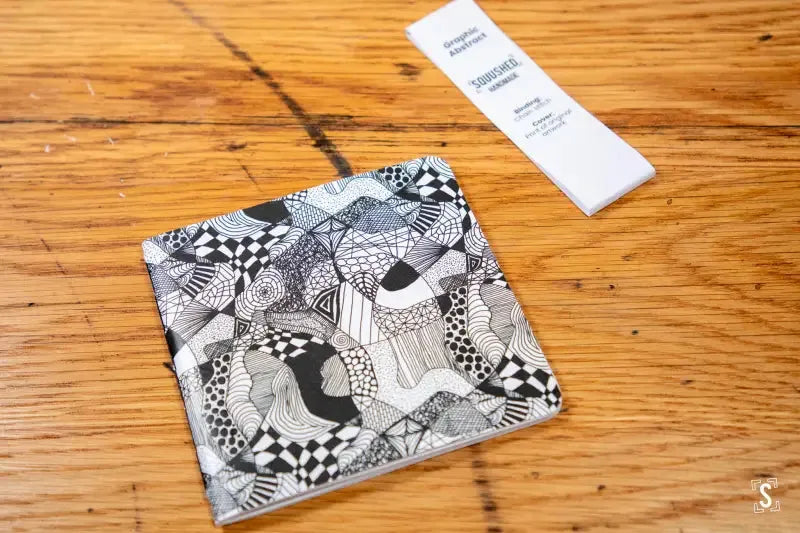 Black and white ceramic tile pattern enhancing Handmade Notebook with Chain Stitch binding