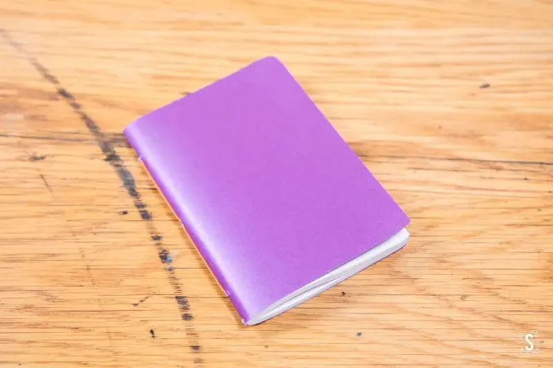 Purple handmade pocket notebook with a plain cover for versatile journaling needs