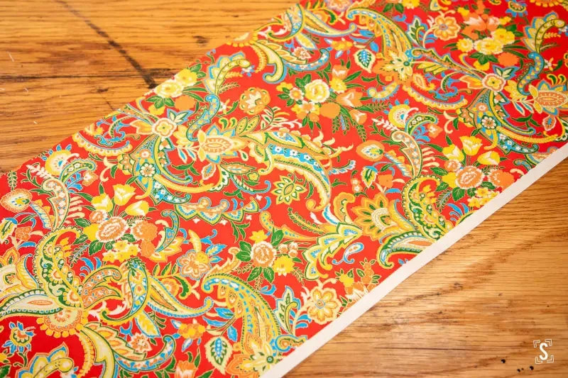 Colorful Japanese Chiyogami fabric featuring intricate paisley prints on red background