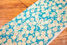 Floral patterned Japanese Chiyogami fabric with white roses on teal background