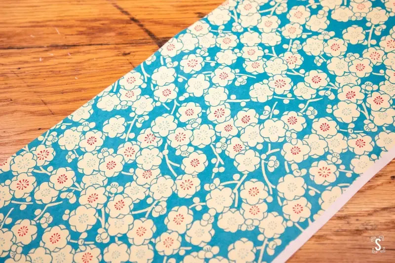 Floral patterned Japanese Chiyogami fabric with white roses on teal background