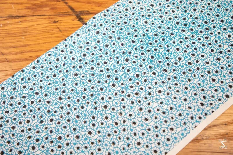 Floral patterned Japanese Chiyogami fabric in light blue with white and dark accents