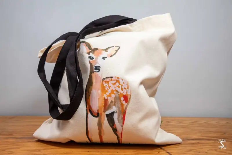 Tote bag with black and white patterned fabric and a yellow strap.