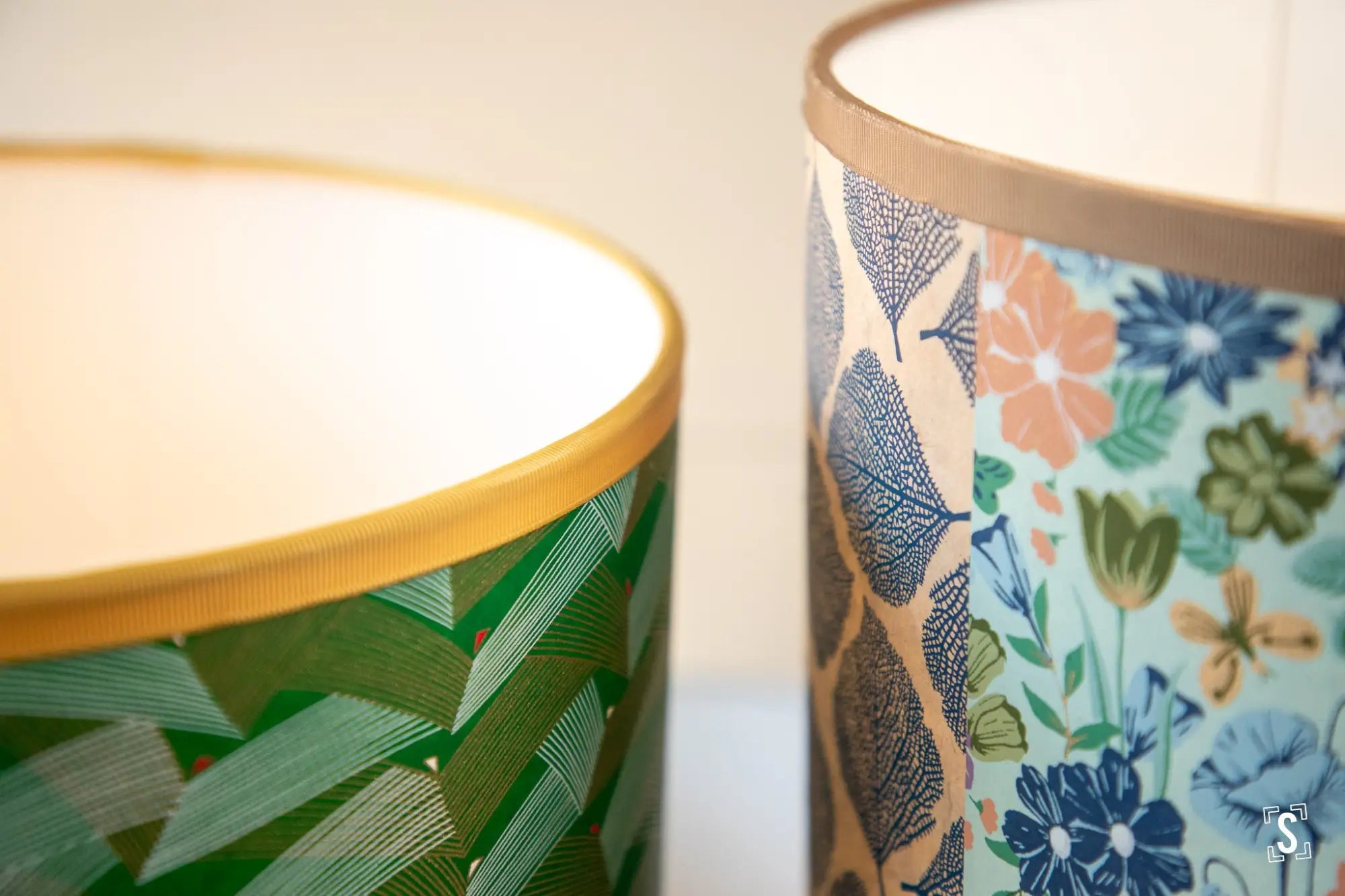 Decorative ceramic mugs or cups with colorful floral patterns.