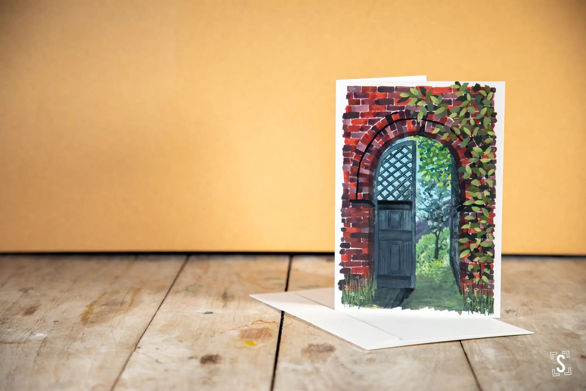 Greeting card featuring a painted arched doorway with ivy and brickwork.