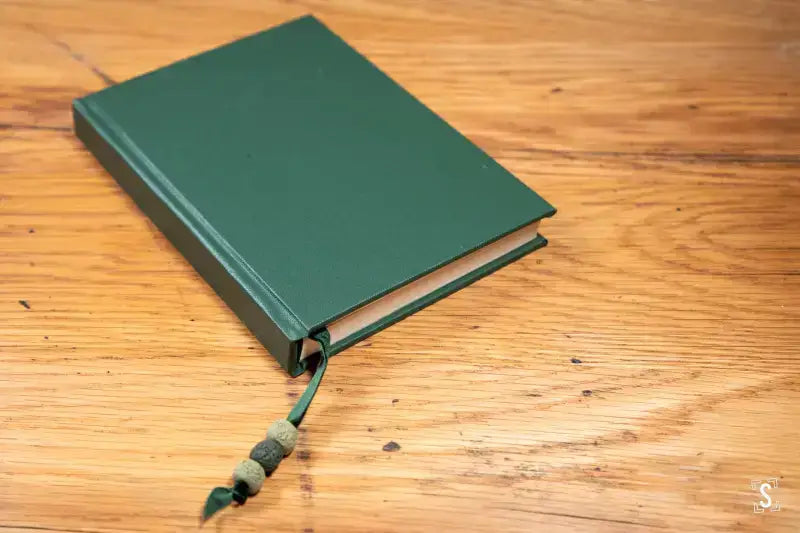 Green hardcover bound book with bookmark ribbon for Bookbinding Workshop February 23 2025