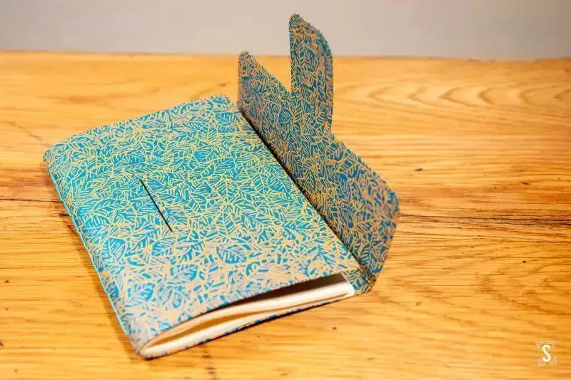 Turquoise and gold notebook cover with flap for Chain Stitch Bookbinding Workshop