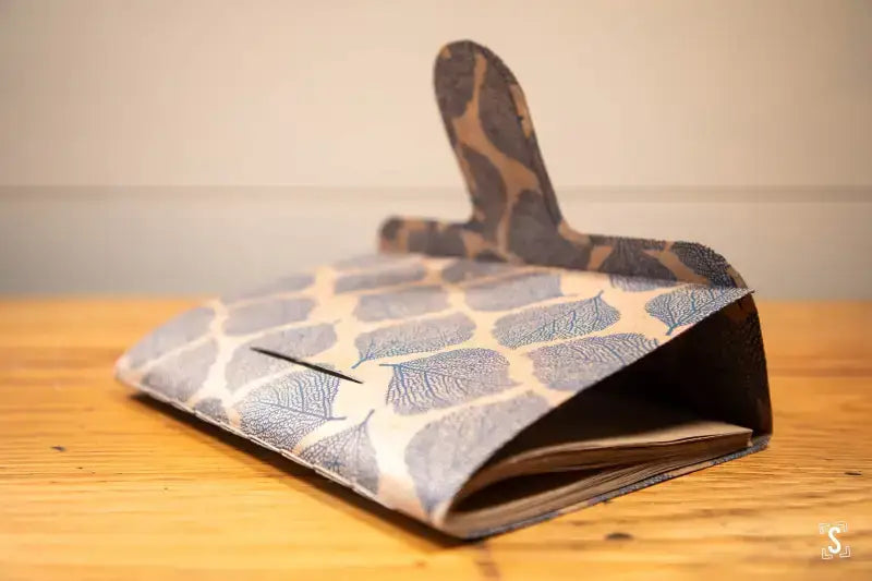 Patterned fabric oven mitt on wood surface, perfect for the Bookbinding Workshop Chain Stitch