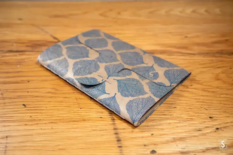 Patterned fabric wallet with geometric design, featured in Bookbinding Workshop Chain Stitch