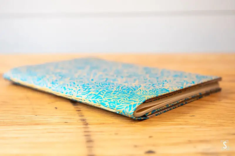 Ornate blue and gold notebook for the Bookbinding Workshop featuring chain stitch design