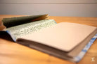 Open notebook with patterned pages for Bookbinding Workshop featuring chain stitch techniques