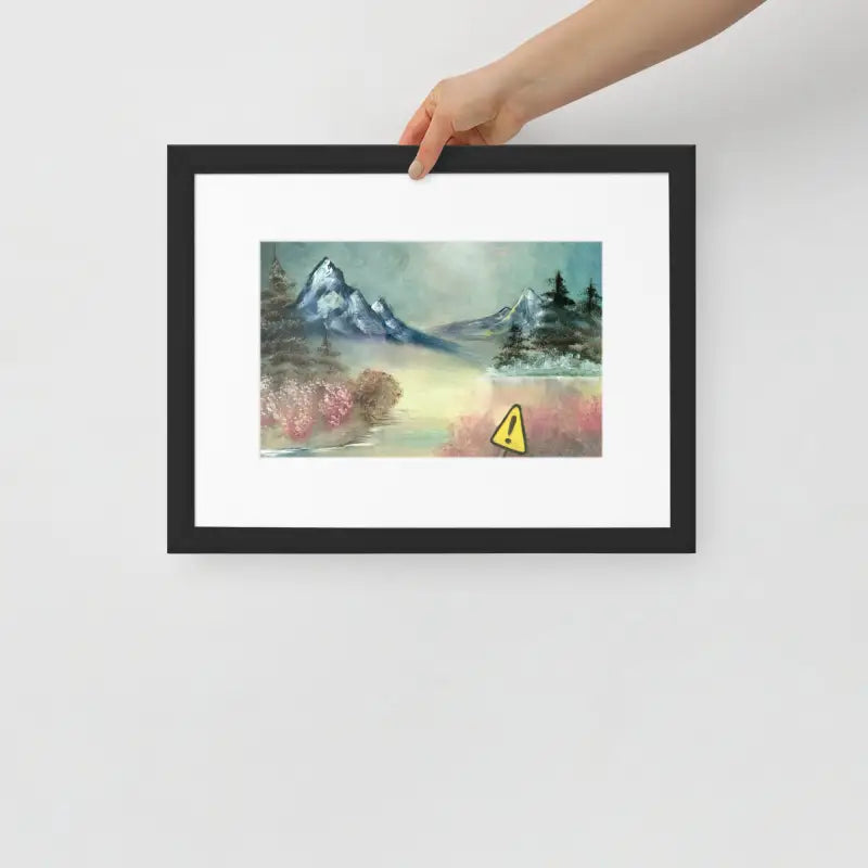 Hand holding a vibrant yellow Framed Poster of a mountain landscape on matte paper