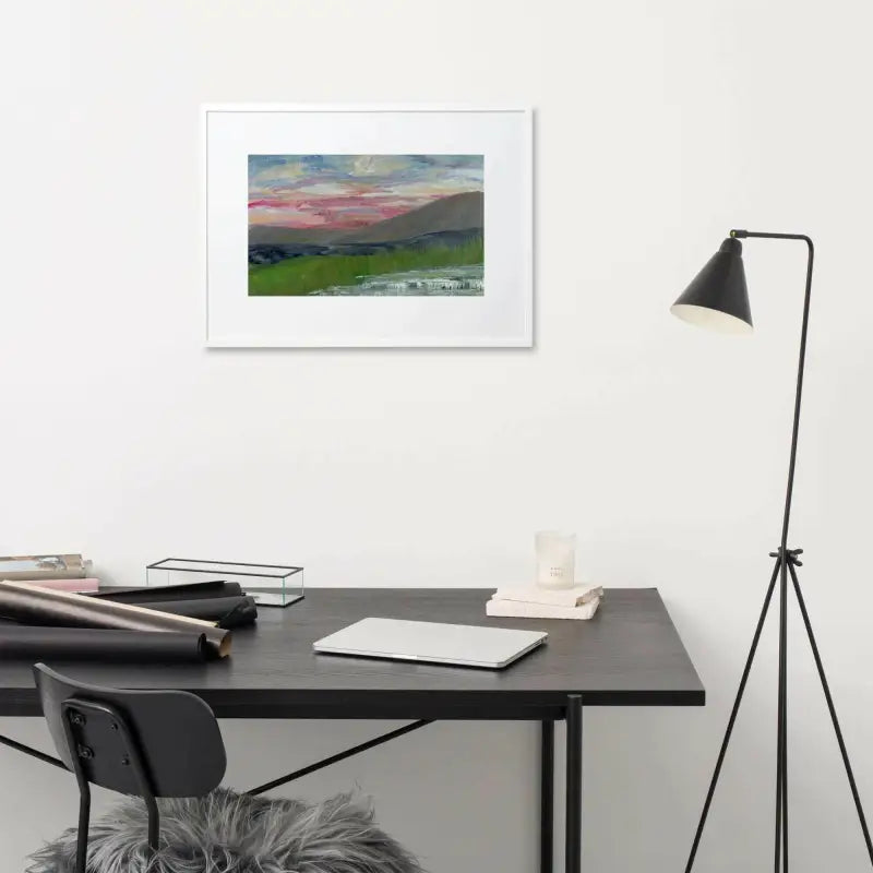 Desk with a black chair and Pink Sky Landscape framed poster on the wall