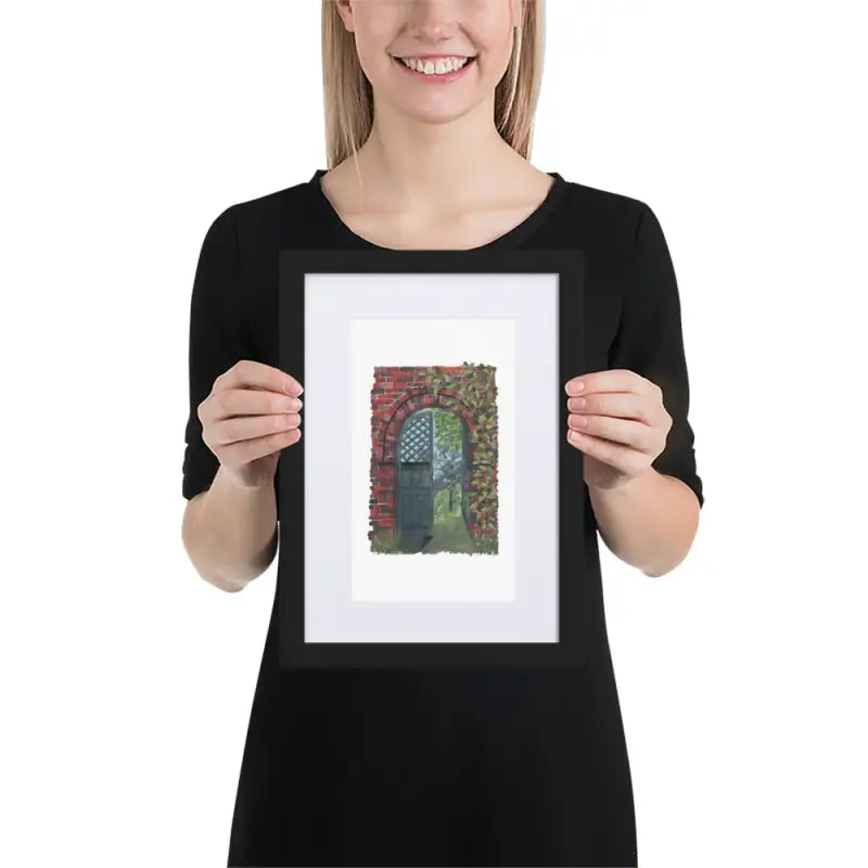 A woman showcasing a Framed Poster of a house with vibrant colours on matte paper