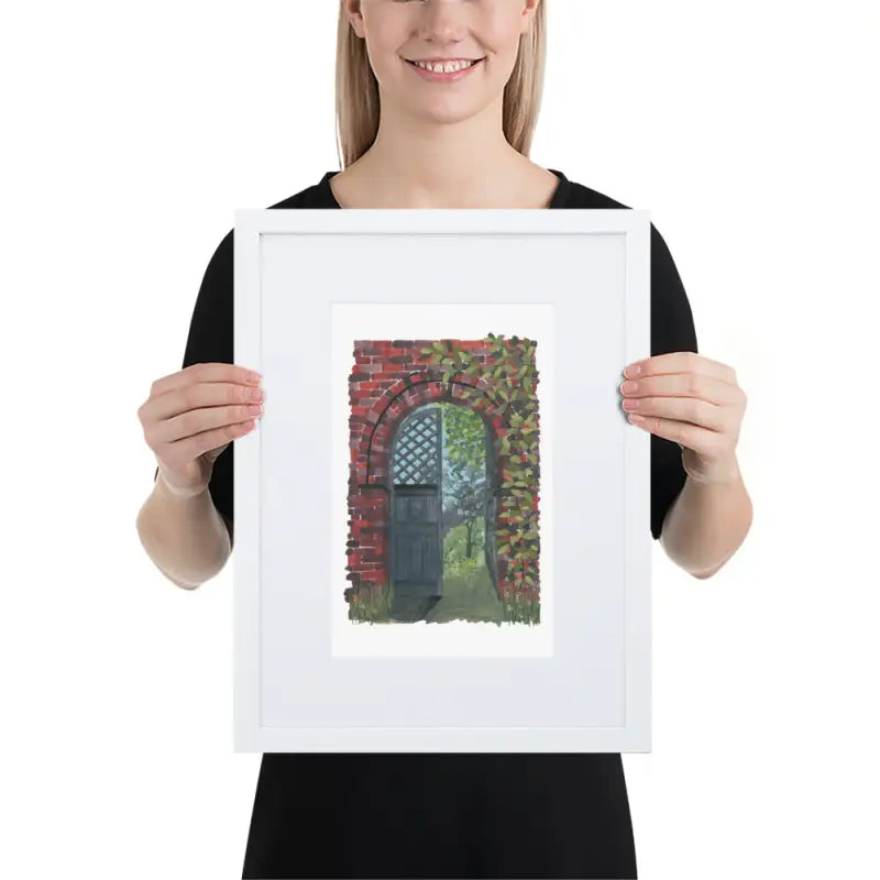 A woman proudly displays a Framed Poster featuring a Secret Door in vibrant colours