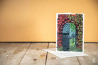 Greeting card featuring a painted arched doorway and vines, premium 150gsm Feltmark