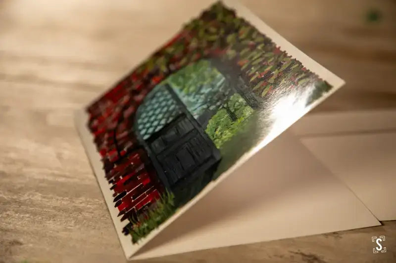 Postcard showcasing a scenic landscape with a red fence, premium 150gsm Feltmark quality