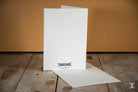 Blank white greeting card on premium 150gsm Feltmark near Greetings Card Behind the Secret Door