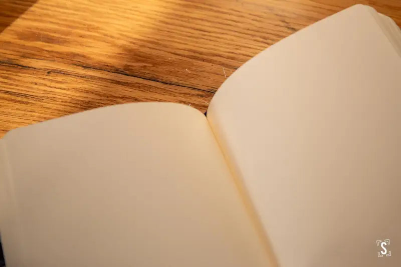 Blank open book with cream pages featuring Italian Carta Varese endpapers