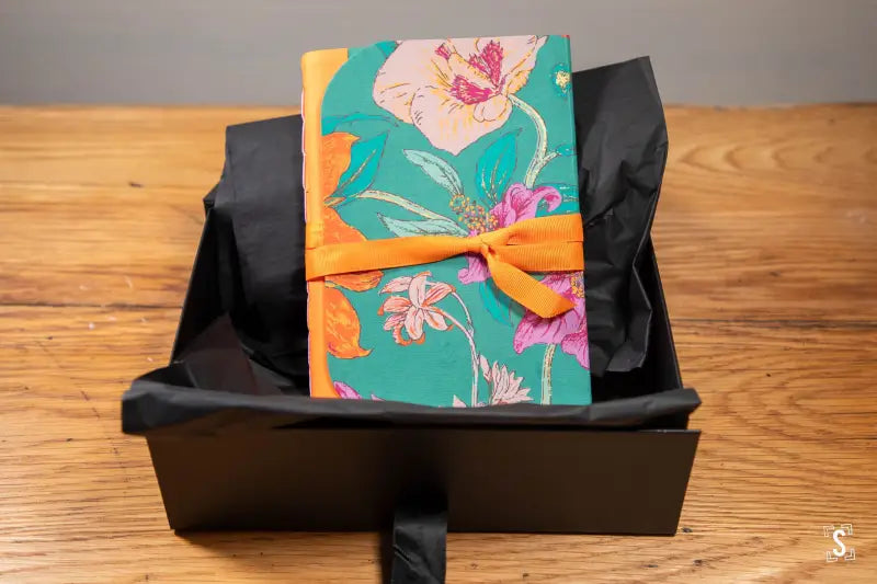 Colorful handmade book featuring Japanese Chiyogami prints with ribbon closure