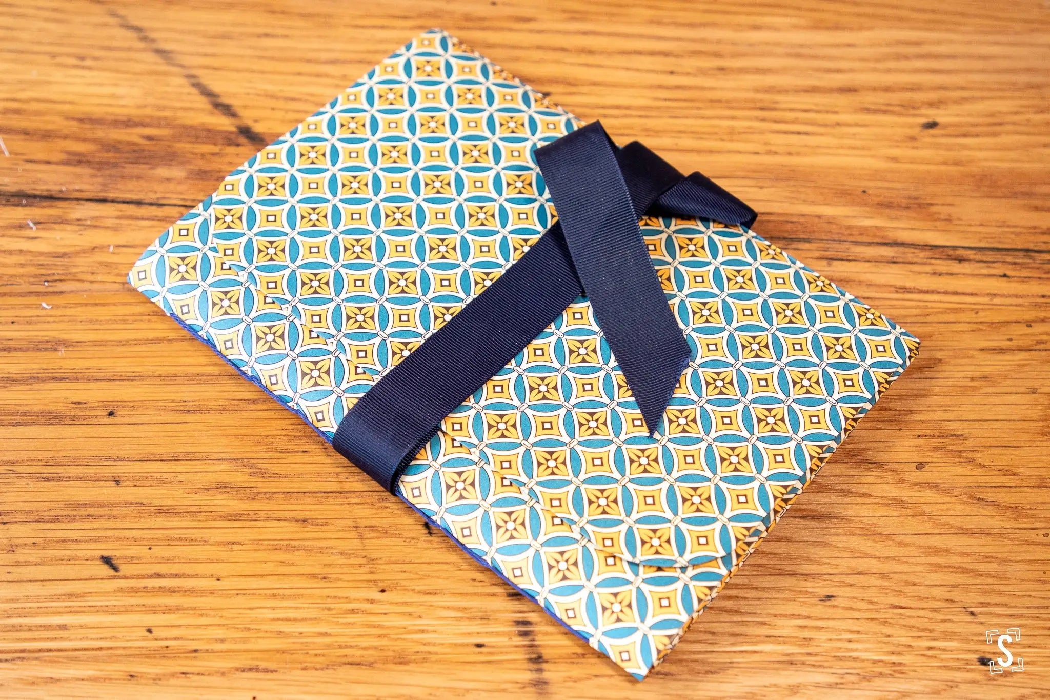 Hand designed patterned notebook with navy ribbon, featuring Italian Carta Varese art