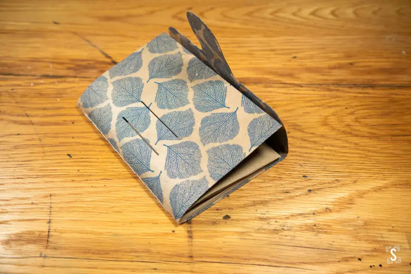 Patterned fabric wallet with geometric leaf design, featuring Tab Closure in Nepalese Lokta