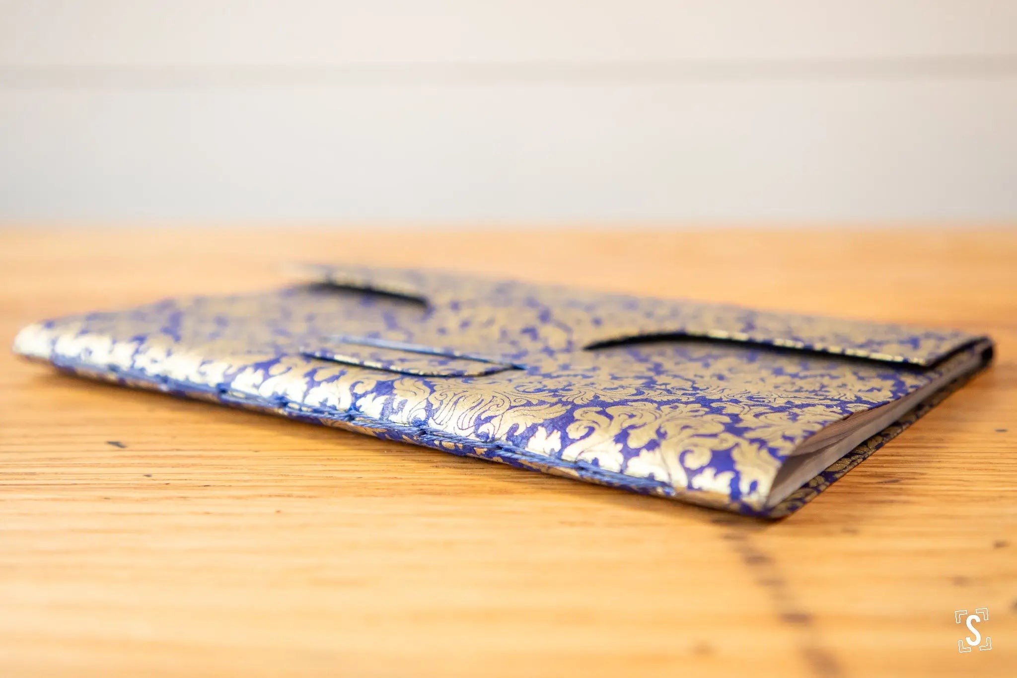 Hand designed ornate wallet featuring blue and gold floral prints in Nepalese Lokta design