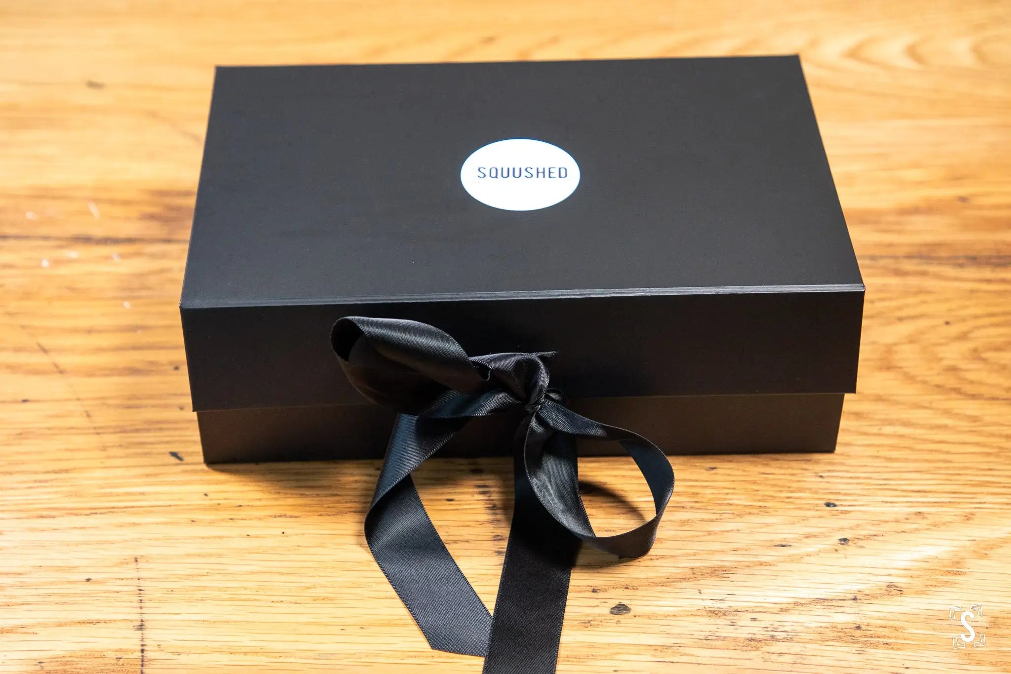 Black gift box with Squished logo, showcasing hand designed Metallic Card and Buckram books