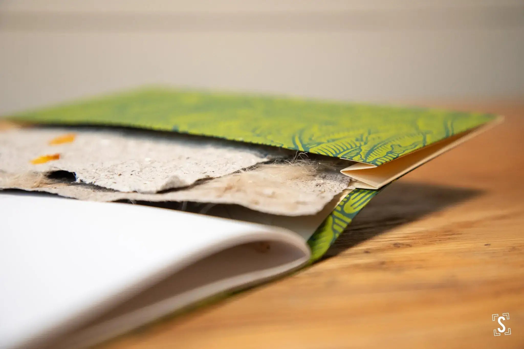 Handmade book with bright green cover, showcasing Chain Stitch and Nepalese Lokta design