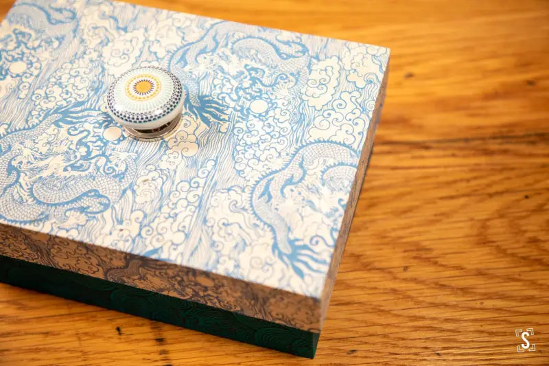 Handmade keepsake box featuring blue and white Lokta paper with a decorative knob