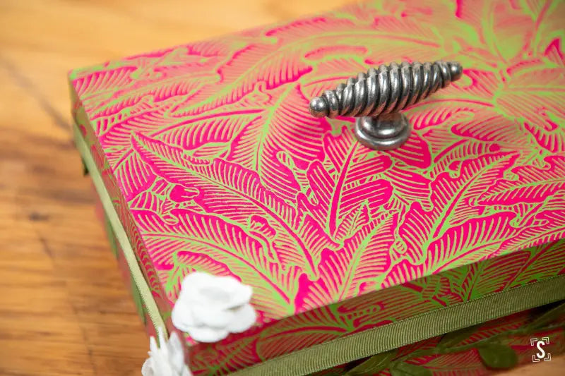 Handmade keepsake box with vibrant pink leaf patterns and metal coil handle