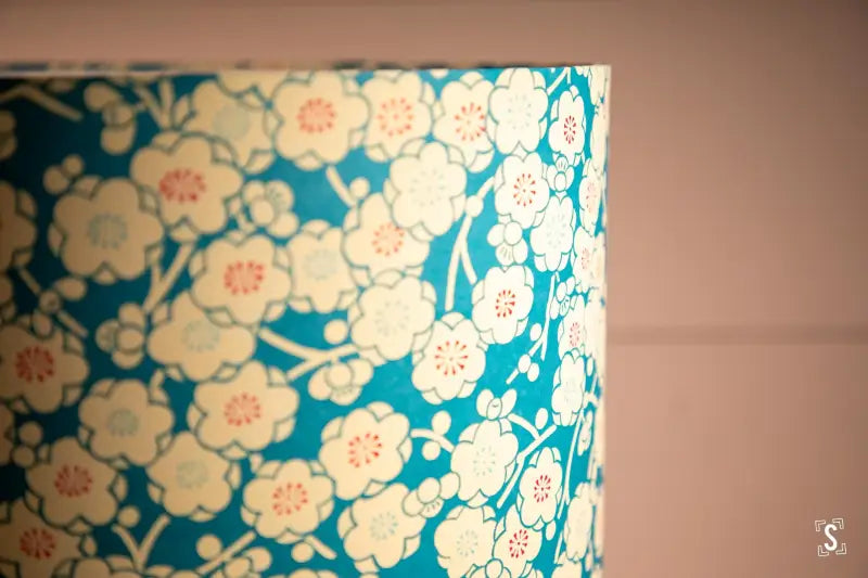 Turquoise handmade lampshade with intricate cherry blossom pattern on chiyogami paper