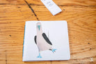 Cartoon-style blue-footed booby illustration on a Handmade Notebook with chain stitch binding