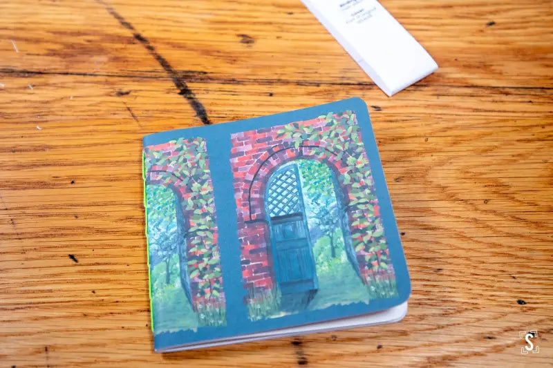 Colorful coaster featuring an arched doorway with floral vines for Handmade Notebook Chain Stitch