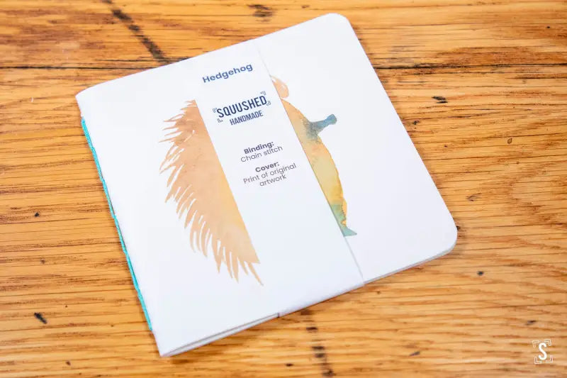 White bathroom scale with feather design on Handmade Notebook with Chain Stitch binding