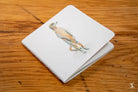 White folded napkin with bird design on Handmade Notebook with Chain Stitch binding