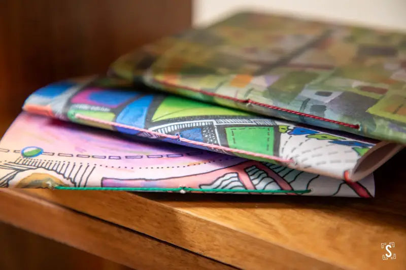 Colorful patterned Handmade Pocket Notebooks elegantly stacked on a surface