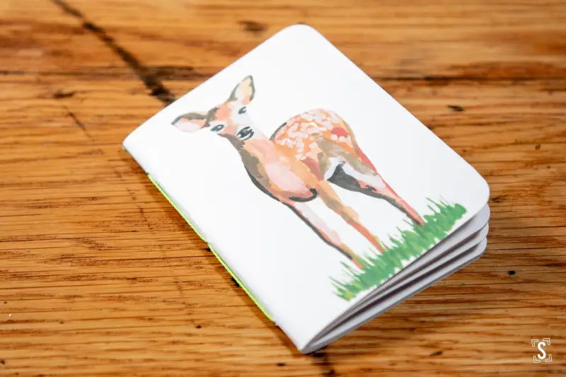 Handmade pocket notebook with a watercolor illustration of a young deer on the cover