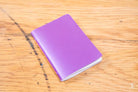 Purple handmade pocket notebook with a plain cover for versatile use