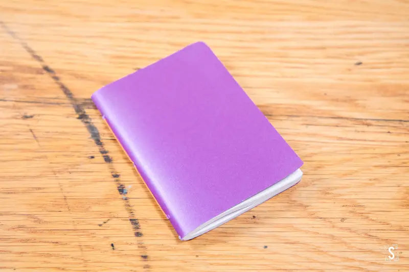 Purple handmade pocket notebook with a plain cover for versatile journaling needs