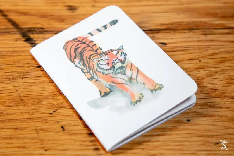 White notebook featuring a watercolor tiger illustration, handmade pocket notebook design