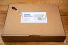 Cardboard box labeled Squushed containing Coptic Stitch bookbinding materials kit