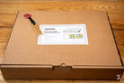 Cardboard shipping box with packing slip and tape measure for Coptic Stitch bookbinding materials