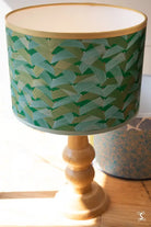 Table lamp with green leaf-patterned shade and wooden base for Lampshade Making Workshop