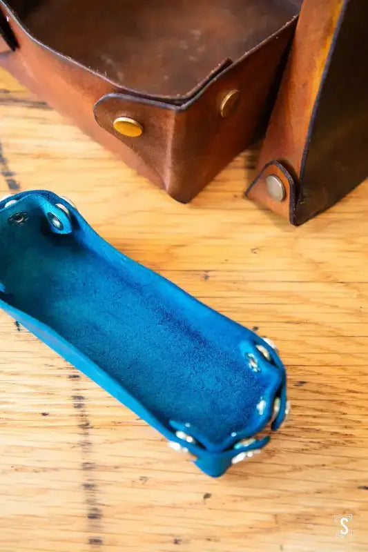 Bright blue ceramic trinket dish with raised edges for the No-Sew Leather Box workshop