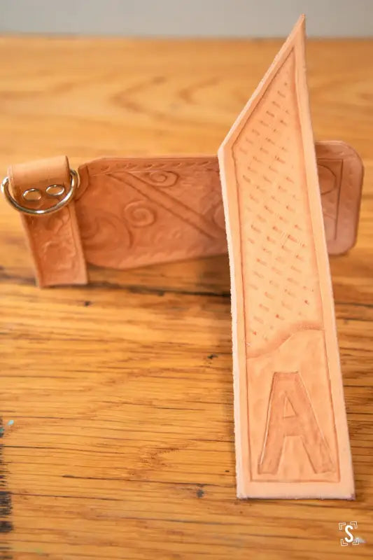 Leather belt with embossed patterns from Leathercraft Workshop, hand designed for elegance