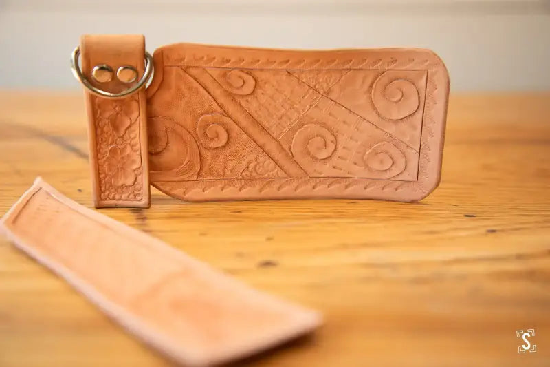 Leather wallet with embossed swirl patterns and snap closure from Leathercraft Workshop