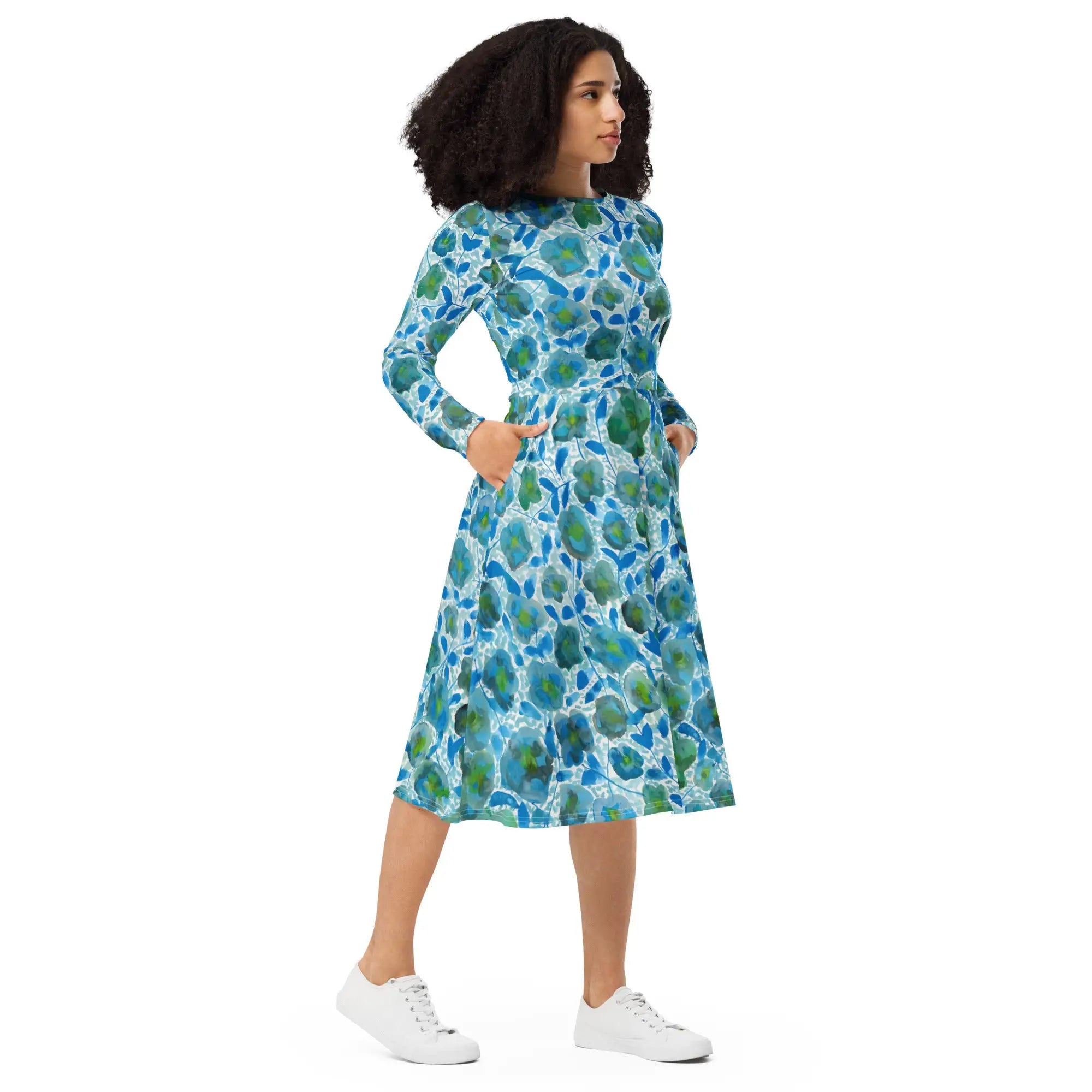 Woman in blue and green long sleeve midi dress with floral pattern