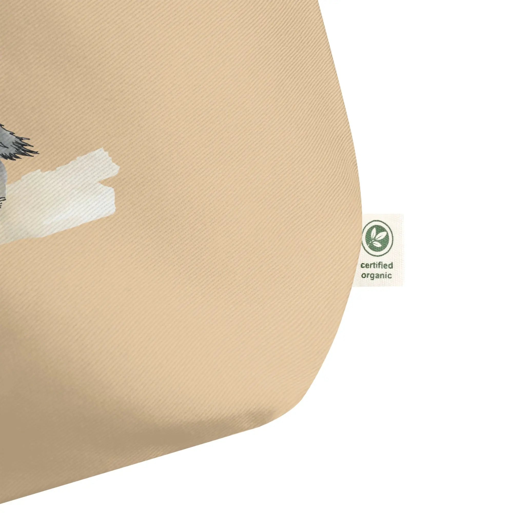 Organic cotton tote bag featuring bird on beige pillow