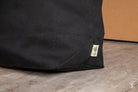 Organic cotton tote bag in black canvas featuring a green logo from Loonar Landing